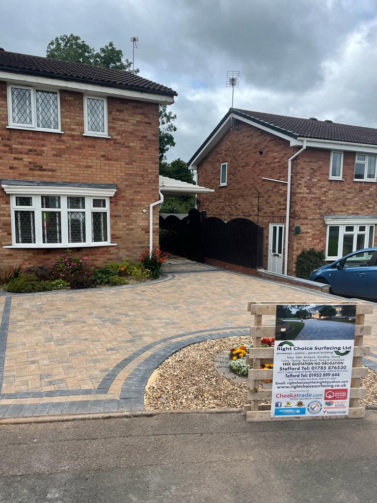 Wide block paved driveway with a circular gravel bed